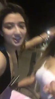 Two friends having fun and flashing on the street