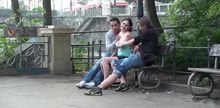 Threesome on a bench with a cute chick